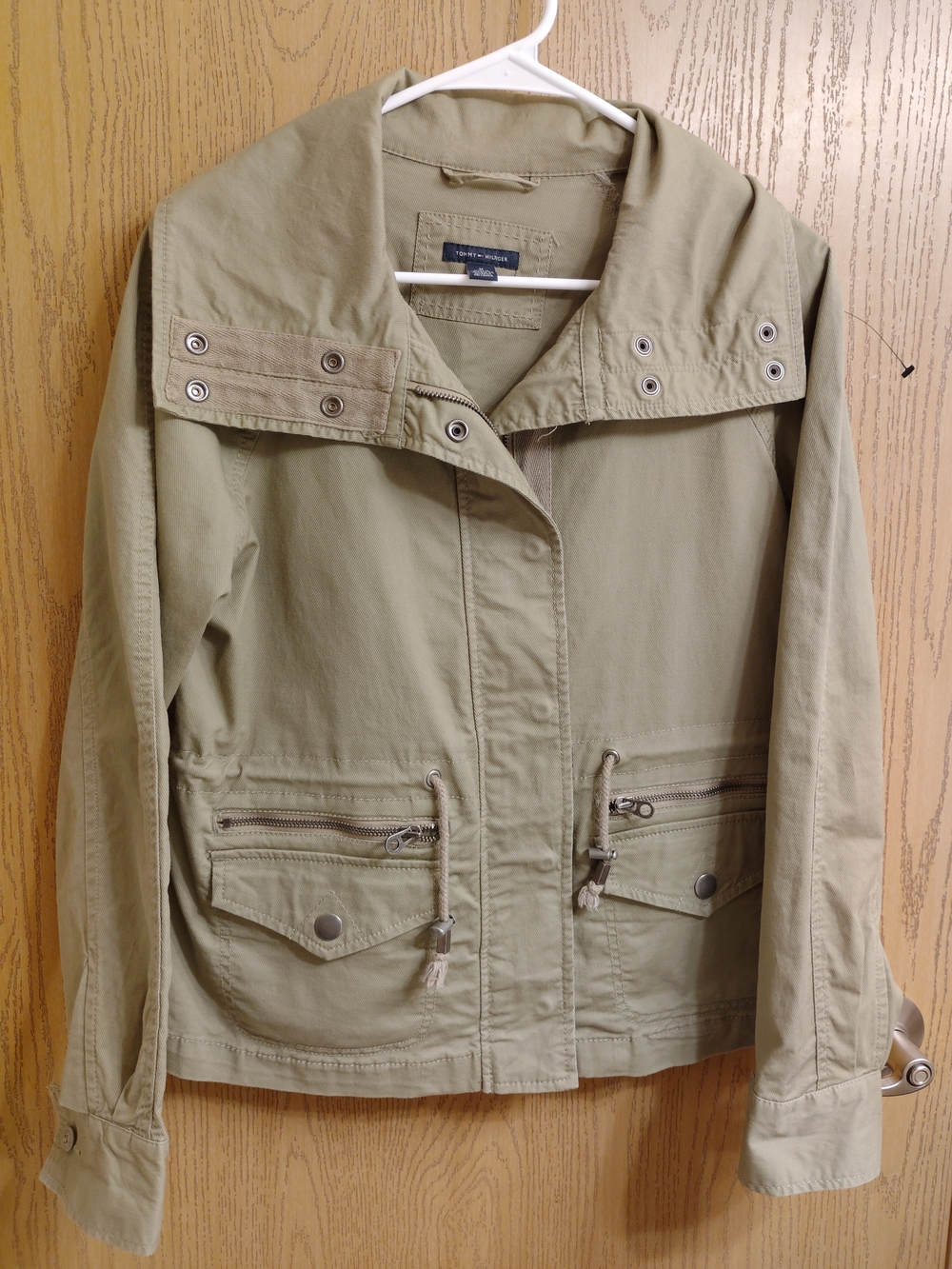 Tommy Hilfiger navy label with red, white and blue flag on olive fabric